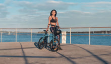 A woman rides a Fiido D11 electric bike to exercise