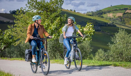 A man and a woman riding Fiido C11 electric bikes on the road