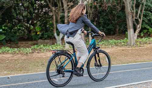 Woman riding a Fiido C11 electric bicycle on the road