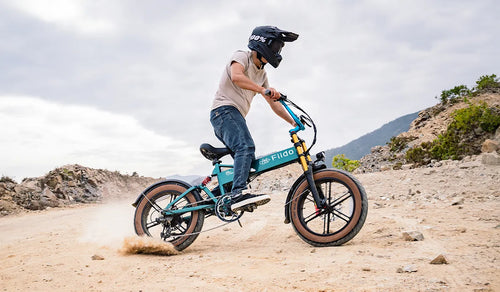 Man riding an upgraded Fiido M1 pro electric bike on the sand