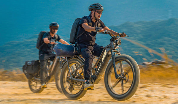 Two men riding electric bikes