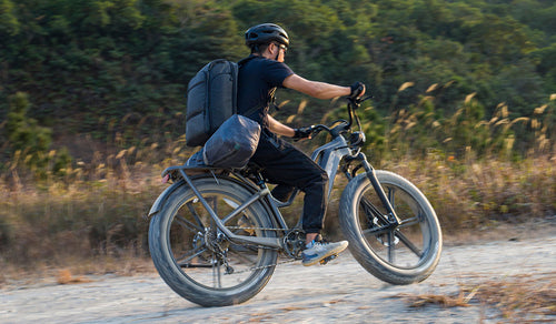 Rider on a Fiido Titan electric bike, tackling off-road trails.