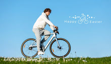 A man rides a Fiido Air electric bike across the lawn