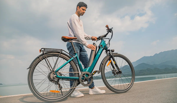 A man is removing the battery from a Fiido C11 pro lightweight electric bicycle.