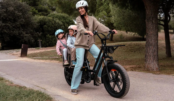 A woman is riding a Fiido T2 dual-seat electric bike with her two children.