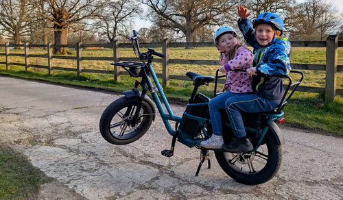 Two children are riding on a Fiido T2 two-seater electric bike.