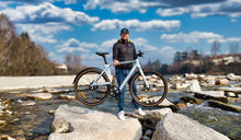 A man effortlessly lifts the Fiido Air lightweight electric bike.