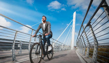 Man riding a Fiido C21 pedal-assist electric bicycle on a bike path