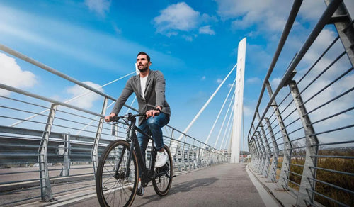 Man riding a Fiido C21 pedal-assist electric bicycle on a bike path