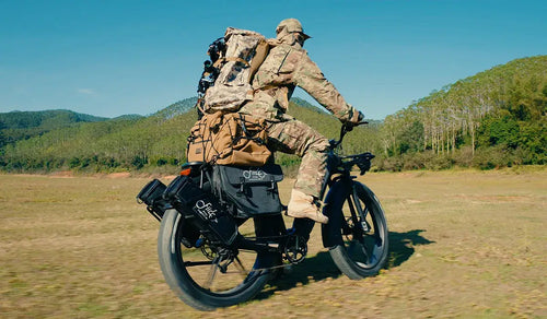 A man prepares to hunt in the wilderness on a Fiido Titan electric bike.