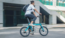 A man commutes to work on a Fiido X foldable electric bicycle.