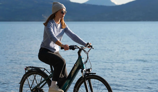 A woman riding a Fiido C11 Pro by the lake.