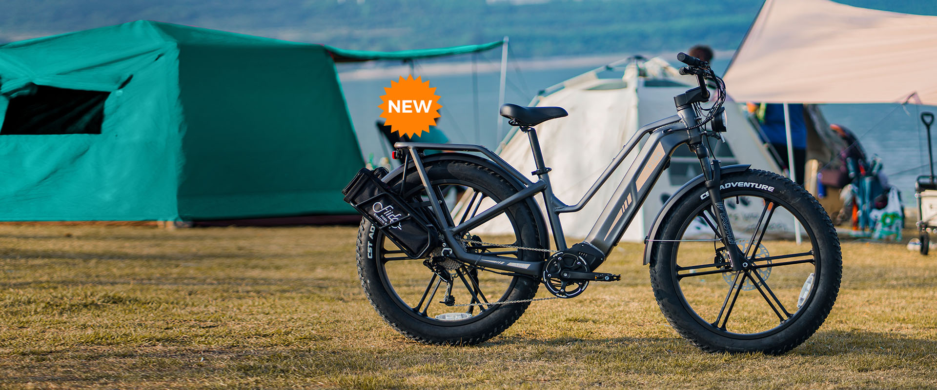 A Fiido Titan electric bike parked next to a tent.