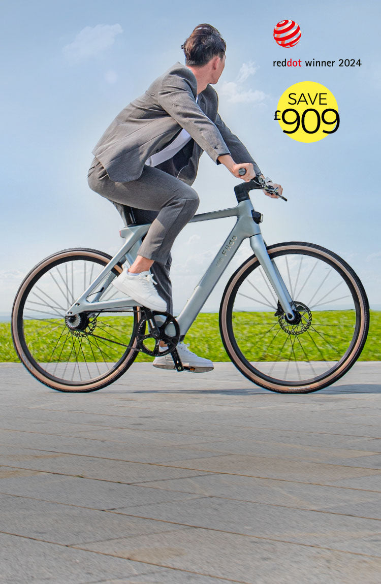 A man in gray clothing rides a Fiido Air electric bike on a highway - m