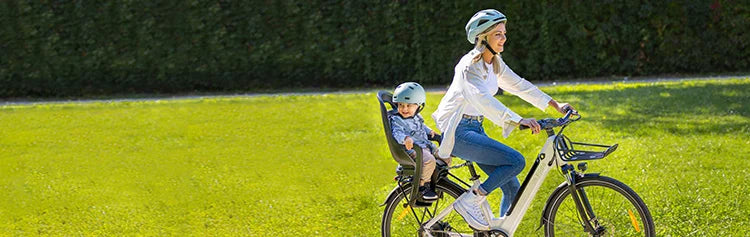 Mother riding a Fiido C11 electric bike out carrying her child